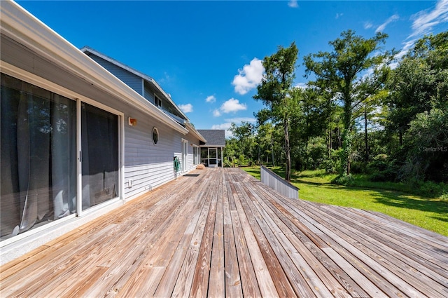 wooden deck featuring a lawn