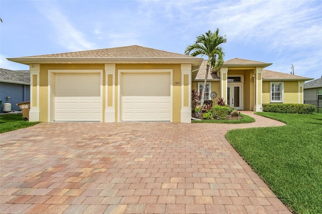 3327 Surfside Blvd, Cape Coral, FL 33914 - prairie-style home with a front lawn, decorative driveway, and stucco siding