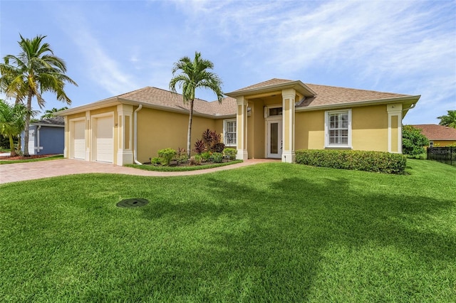 view of front of property with a garage and a front yard