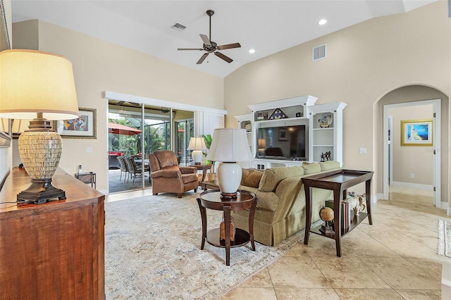 living room featuring light tile patterned floors, ceiling fan, and high vaulted ceiling