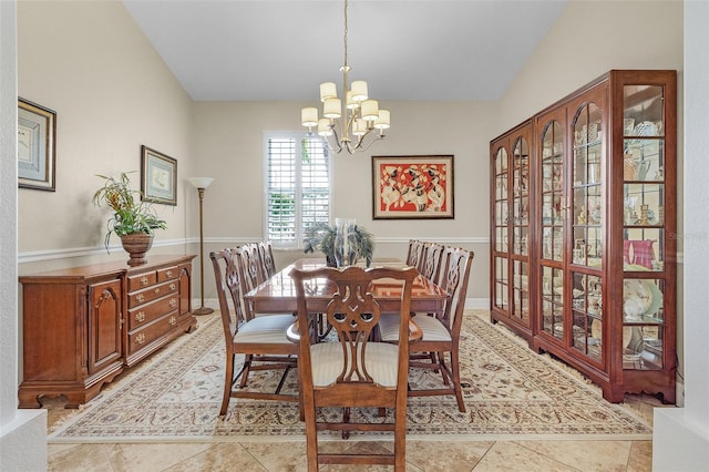 dining room featuring vaulted ceiling, a notable chandelier, and light tile patterned floors