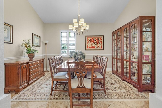 3327 Surfside Blvd, Cape Coral, FL 33914 - dining space featuring a notable chandelier, light tile patterned flooring, and vaulted ceiling
