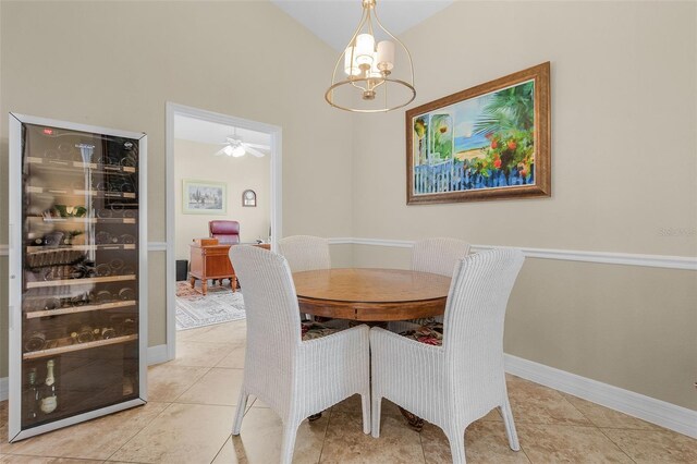 dining space featuring lofted ceiling, a chandelier, wine cooler, and light tile patterned floors