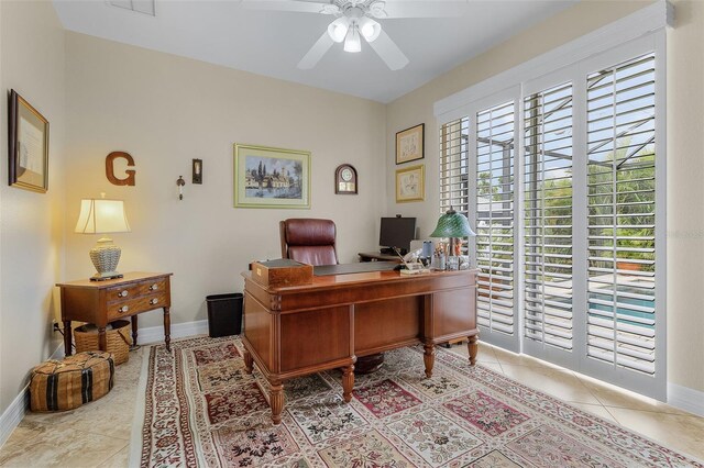 office space featuring light tile patterned floors and ceiling fan