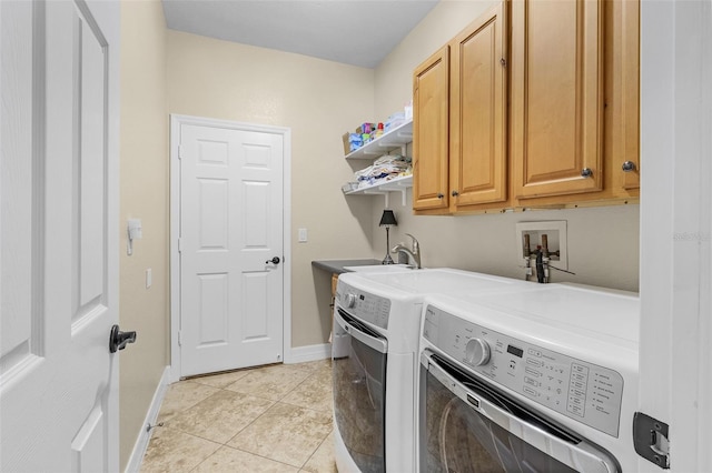 laundry room with light tile patterned flooring, washing machine and dryer, and cabinets