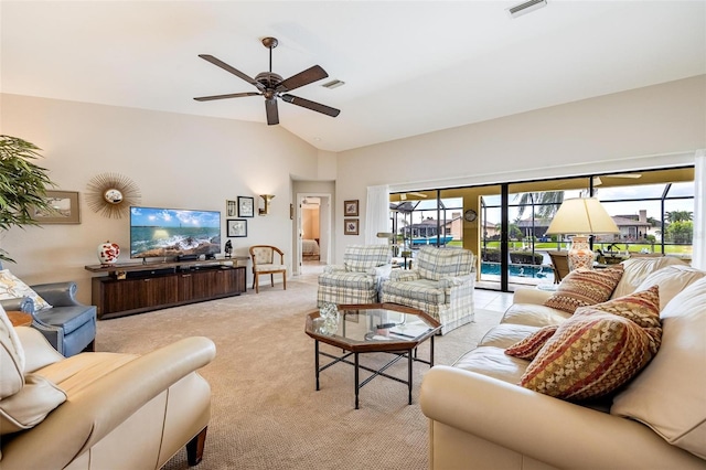 carpeted living room with ceiling fan and lofted ceiling