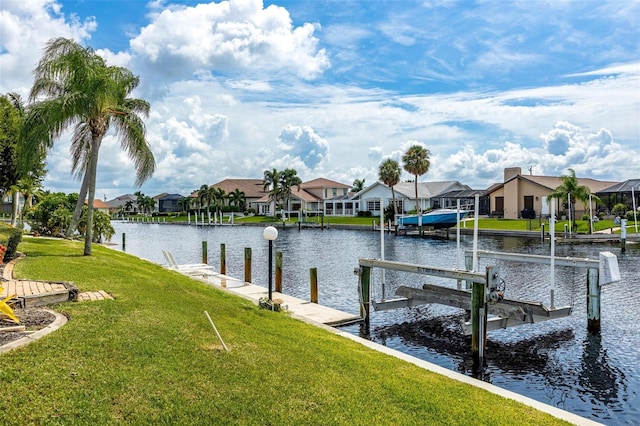 dock area featuring a lawn and a water view