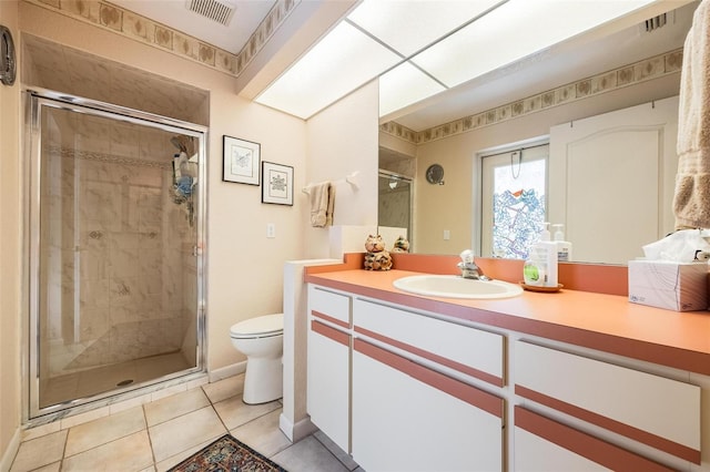 bathroom with toilet, an enclosed shower, tile patterned floors, and vanity