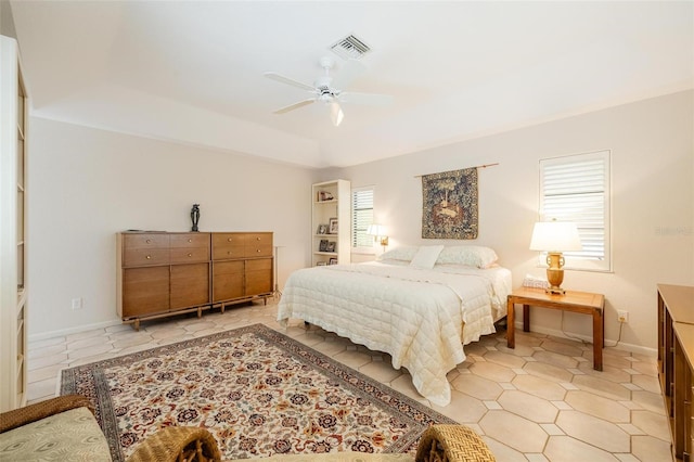 bedroom featuring ceiling fan and a raised ceiling