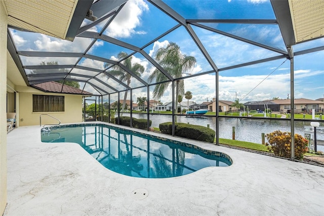 view of swimming pool with a lanai, a water view, and a patio