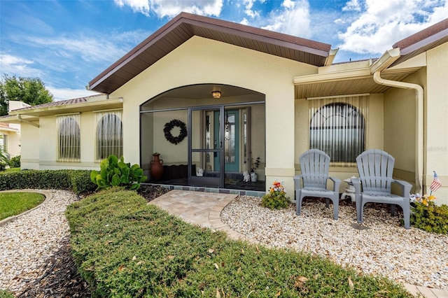 doorway to property with stucco siding