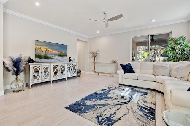 living room featuring ornamental molding, light wood-type flooring, and ceiling fan