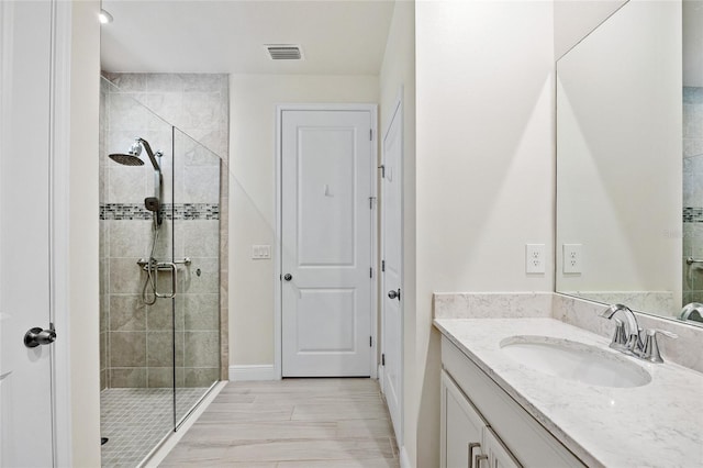 bathroom with vanity and an enclosed shower