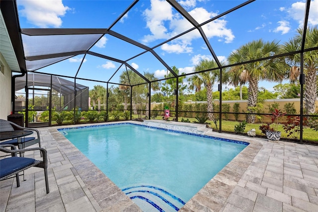 view of swimming pool featuring a patio, pool water feature, and glass enclosure