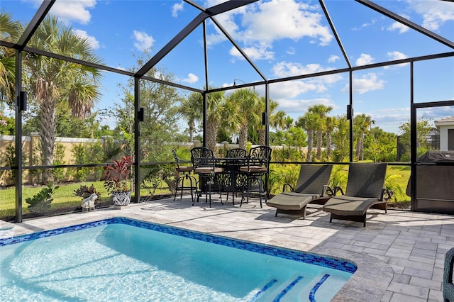 view of swimming pool featuring a lanai and a patio area