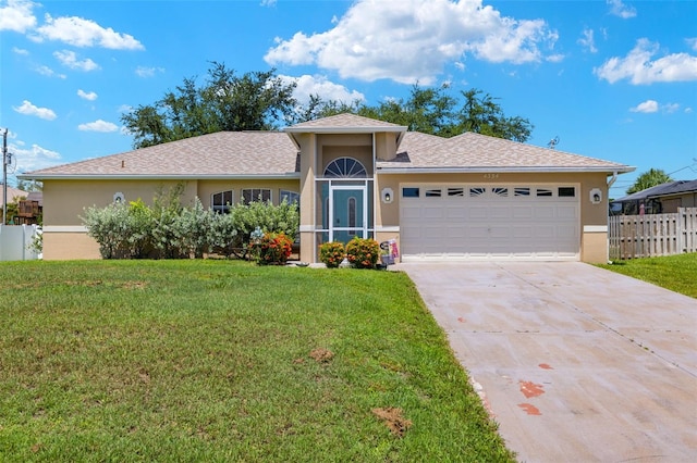 view of front of property featuring a garage and a front yard