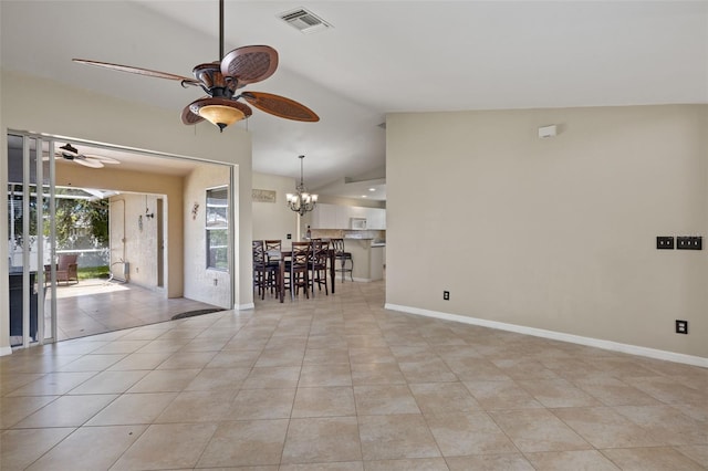 tiled empty room with ceiling fan with notable chandelier and vaulted ceiling