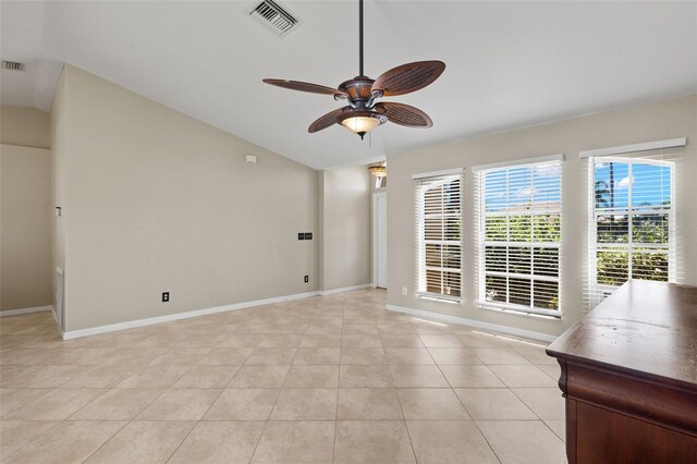 interior space with lofted ceiling, light tile patterned floors, and ceiling fan