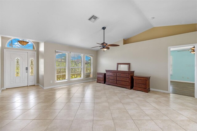 tiled foyer featuring ceiling fan and lofted ceiling