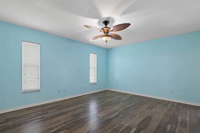 unfurnished room with dark hardwood / wood-style floors and ceiling fan