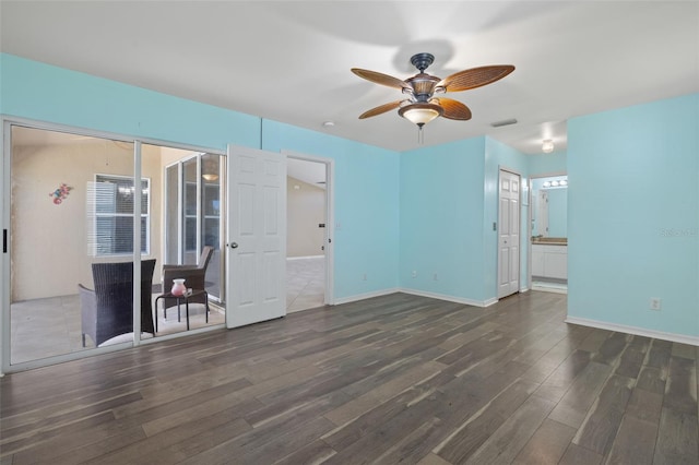 unfurnished living room with ceiling fan and dark hardwood / wood-style floors