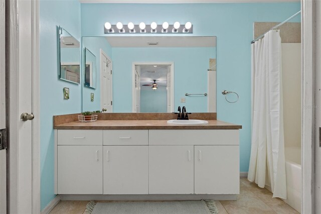 bathroom featuring shower / tub combo, tile patterned floors, and vanity