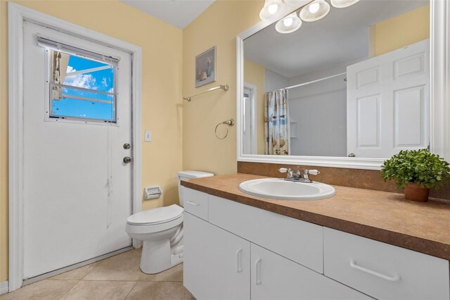 bathroom featuring tile patterned floors, toilet, and vanity