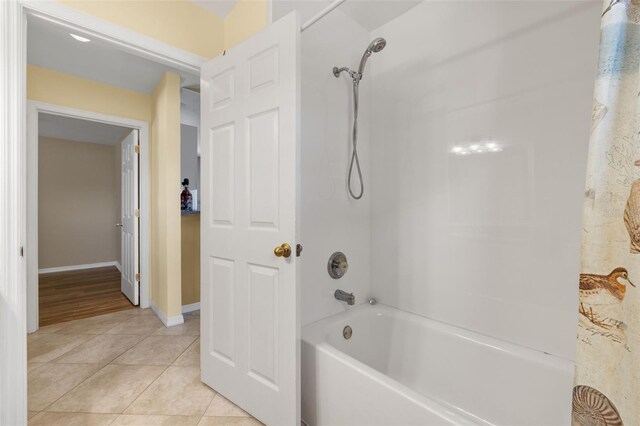 bathroom with bathing tub / shower combination and hardwood / wood-style flooring