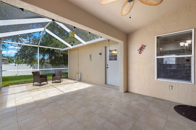 unfurnished sunroom featuring ceiling fan