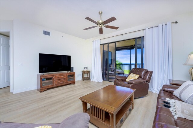 living room with ceiling fan and light hardwood / wood-style flooring