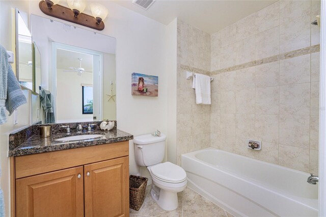 full bathroom with ceiling fan, vanity, tiled shower / bath combo, and toilet