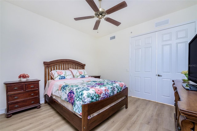 bedroom with ceiling fan, a closet, and light hardwood / wood-style flooring