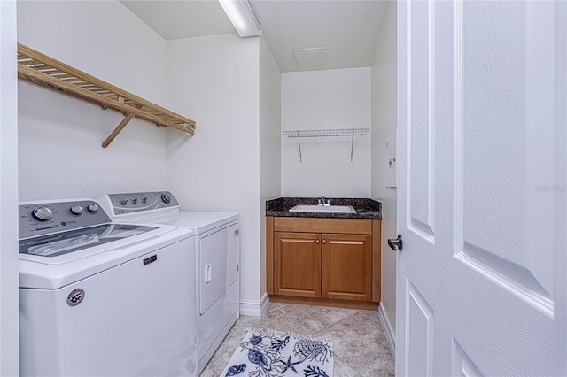 washroom with separate washer and dryer and sink