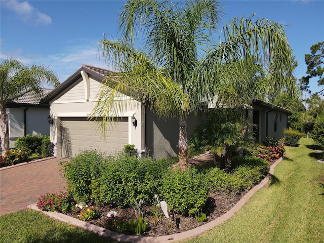 view of side of property with a garage and a yard