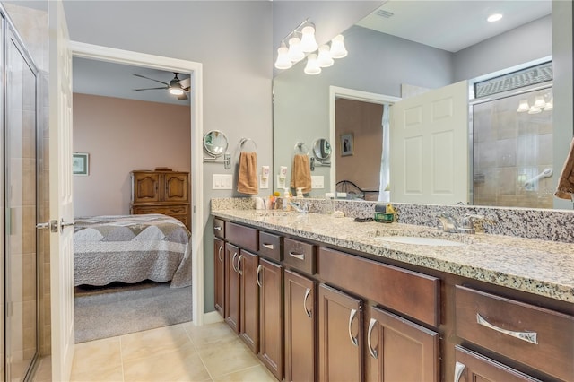 bathroom with tile patterned flooring, walk in shower, double sink vanity, and ceiling fan