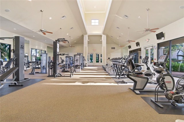 workout area with high vaulted ceiling, a wealth of natural light, and ceiling fan