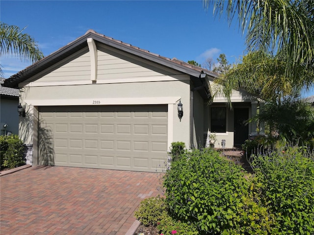 ranch-style home featuring a garage