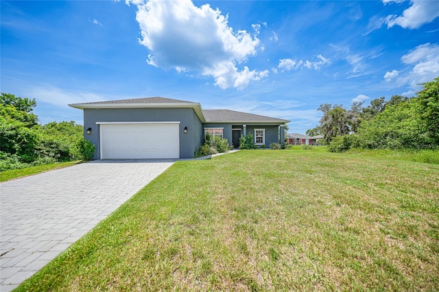 single story home with a garage and a front lawn