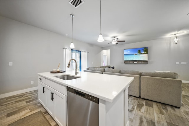 kitchen with sink, dishwasher, a kitchen island with sink, and white cabinetry