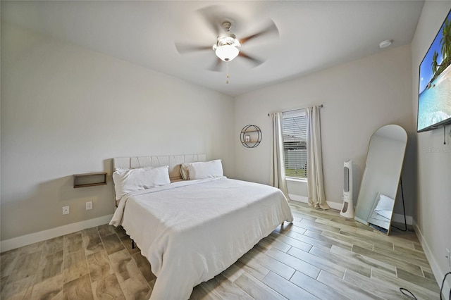 bedroom with ceiling fan and light hardwood / wood-style floors