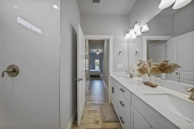 bathroom featuring hardwood / wood-style floors and dual bowl vanity