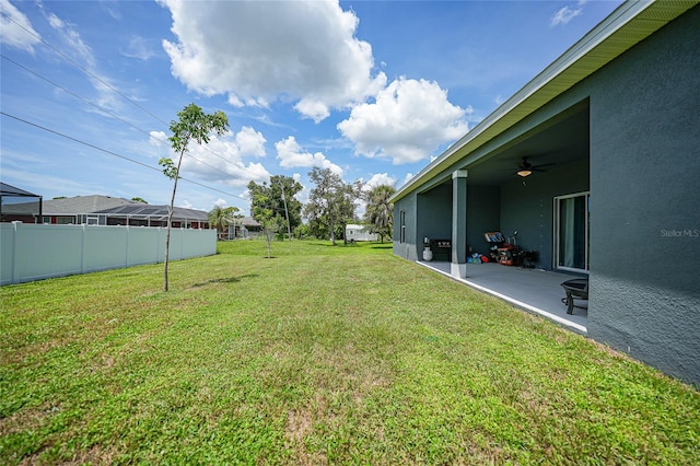 view of yard with a patio and ceiling fan