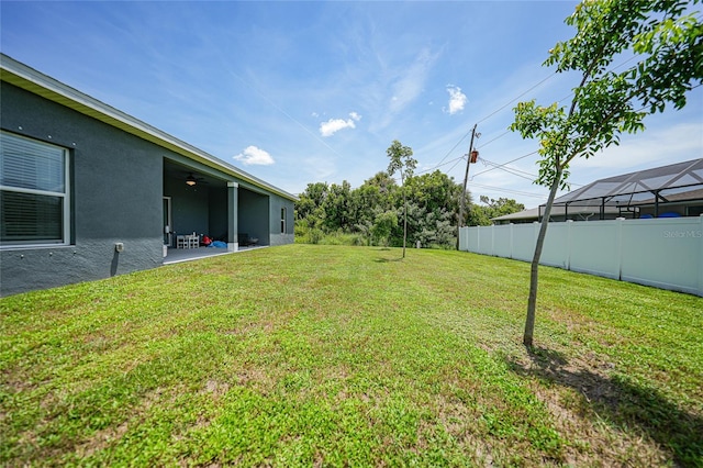 view of yard with a ceiling fan, a patio area, and fence