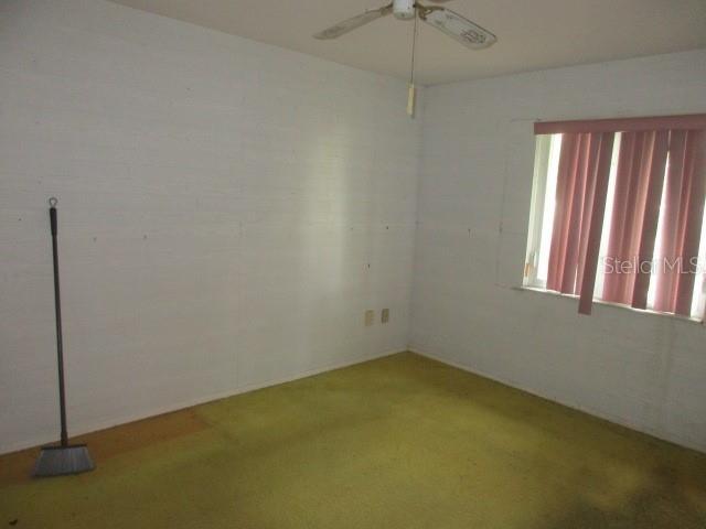 unfurnished room featuring carpet floors and ceiling fan