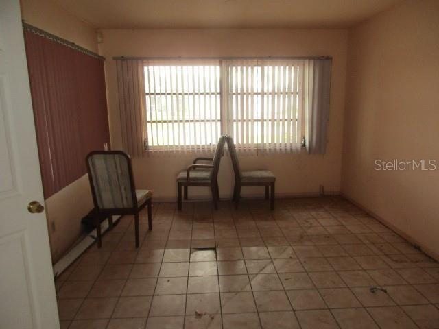 unfurnished room with tile patterned flooring