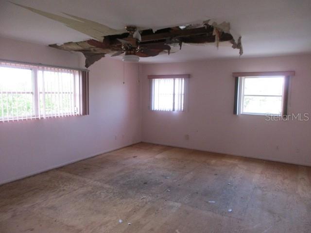 empty room with a healthy amount of sunlight and ceiling fan