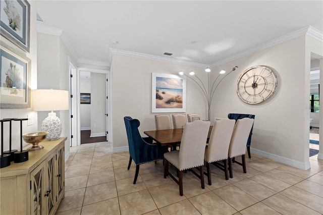 dining space featuring light tile patterned floors and crown molding