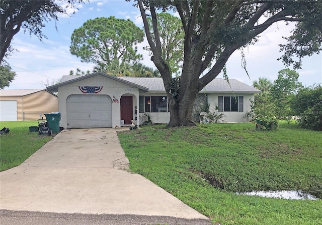 ranch-style home featuring a garage and a front yard