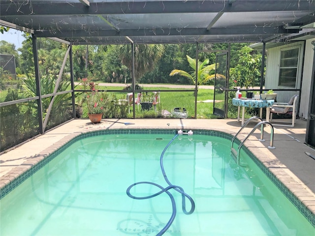 view of swimming pool with a lanai and a patio