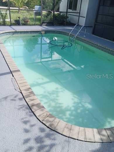 view of pool with a lanai